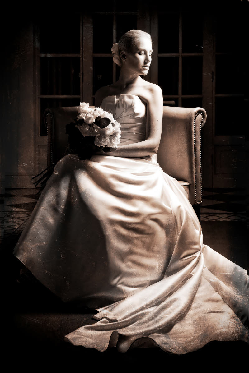 Sitting bride wearing strapless ball gown style dress - photo by South Africa based wedding photographer